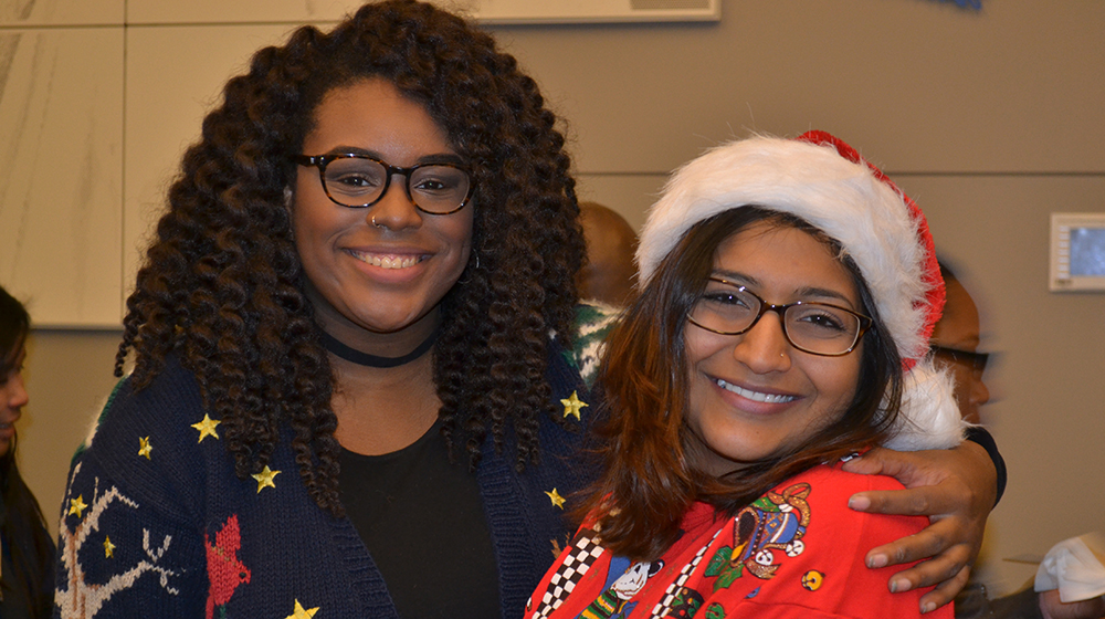 two women hugging and smiling at Dessert in December 2013 event